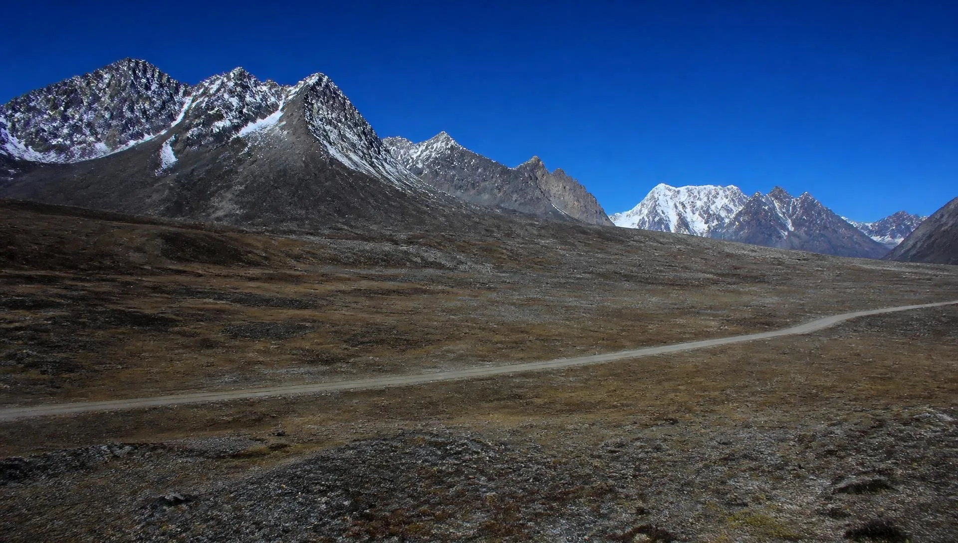 Vast high-altitude plateau and snow-streaked peaks in North Sikkim